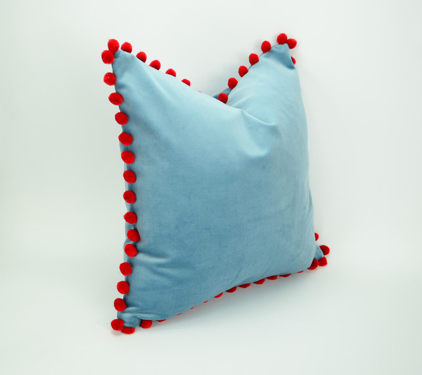 Blue velvet pillow with red pom poms // blue and red pillow // velvet pom pom pillow // pom pom pillow // pom pom cushion